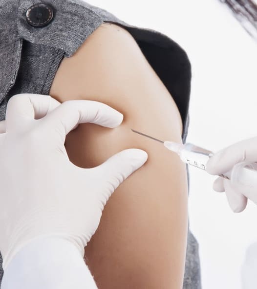 Injection administered in upper arm by nurse.