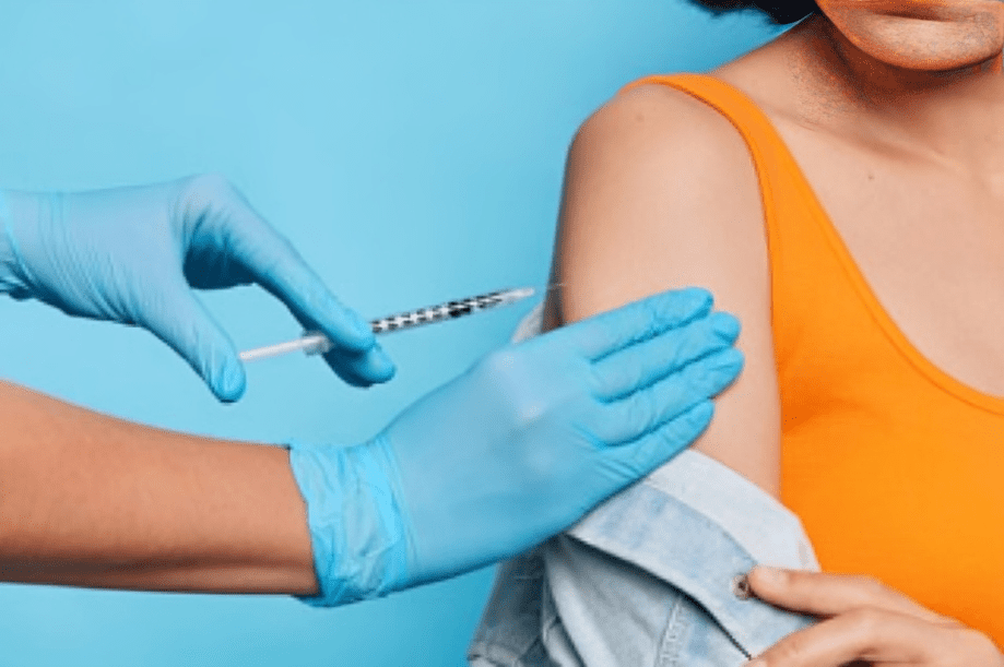 Person receiving vaccine injection in arm.