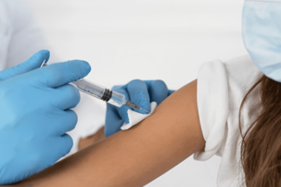 Person receiving vaccination in the arm.