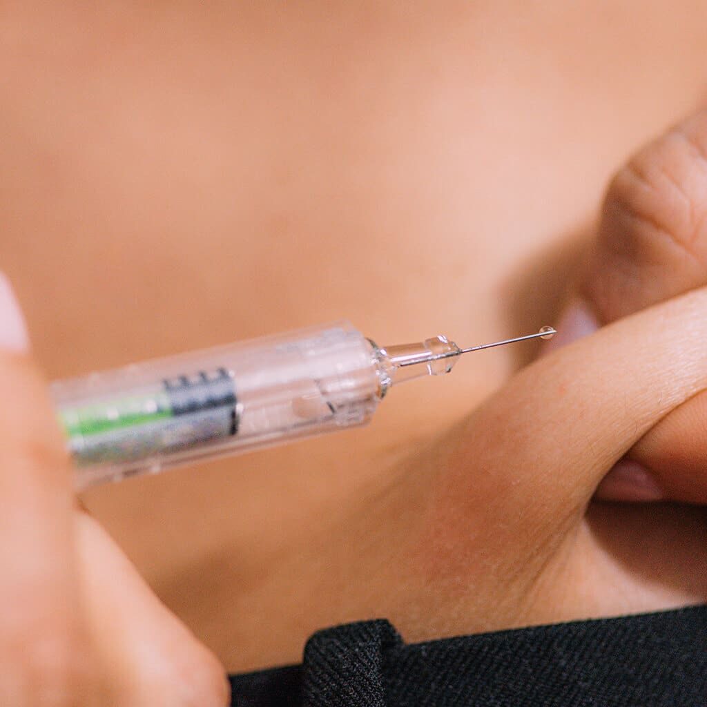 Injection being administered into the skin.